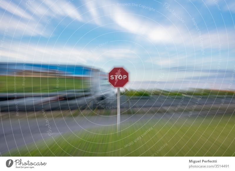 "Stop" traffic sign and a moving truck driving on the road, all under a zoom effect stop stop sign symbol warning danger safety red blue sky white halt
