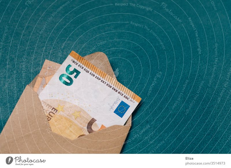 A brown envelope with a bank note inside. Yield. Profit. Gift of money. Bank note Money Envelope 50s 50 euros Euro pretence Donate Donation Invoice Mail