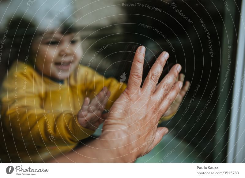 Child touching father hand through glass Quarantine Quarantine period coronavirus sars pandemic COVID covid-19 prevention Epidemic Contagious infectious