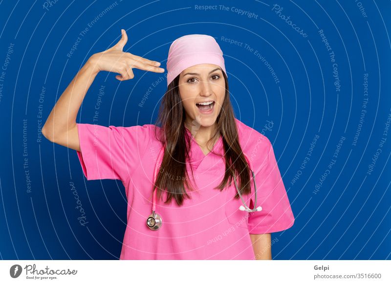 Young doctor with a pink uniform thoughtful mind finger indicate worried pensive think imagine imagination idea solution doubt doubtful thinking smart knowlenge