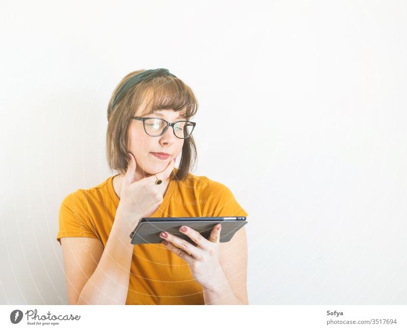 Smiling young woman in yellow using tablet. online shopping person mobile student lifestyle quarantine school adult smiling stay home smart cute funny portrait