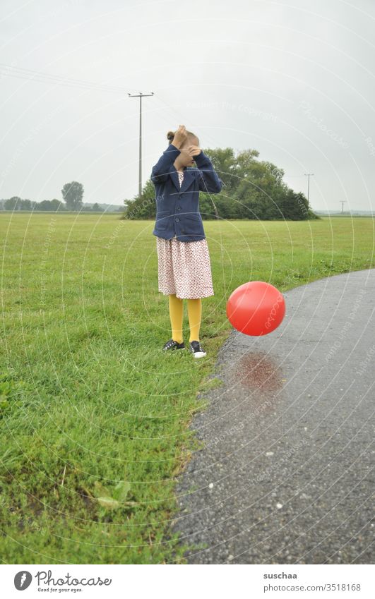 old fashioned dressed girl playing with a red balloon Child out off Meadow Grass Field Balloon Round Playing Environment Landscape Nature Exterior shot Infancy