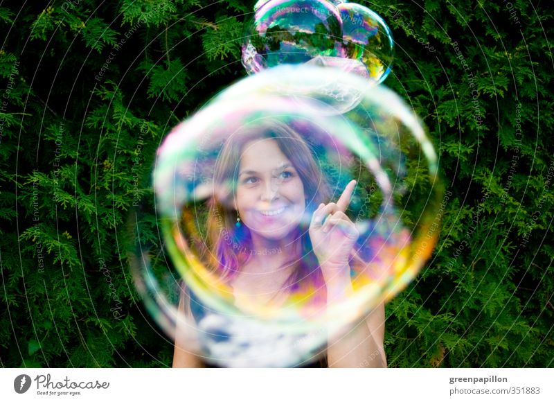 Catch soap bubbles Feminine Young woman Youth (Young adults) Infancy Playing Soap bubble Garden Sphere Blow Bubble Woman Rainbow Prismatic colors Mirror image