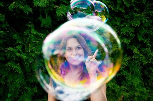 Catch soap bubbles Feminine Young woman Youth (Young adults) Infancy Playing Soap bubble Garden Sphere Blow Bubble Woman Rainbow Prismatic colors Mirror image