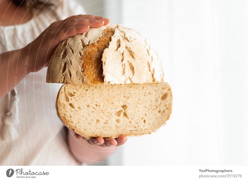 Sourdough bread hold in hands. No yeast bread artisan bread baked goods bakery carbs consumerism crust crusty fermentation food freshly baked golden crust