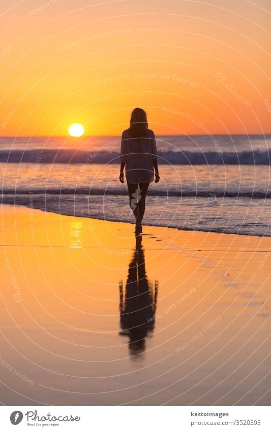 Lady walking on sandy beach in sunset. sea woman summer footprint footstep landscape coastline vacation water nature female waves beautiful ocean barefoot