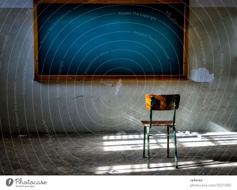 Abandoned classroom with chair in front of the vintage blackboard blank abandon abandoned office grunge interior broken down old dilapidated exploration urban