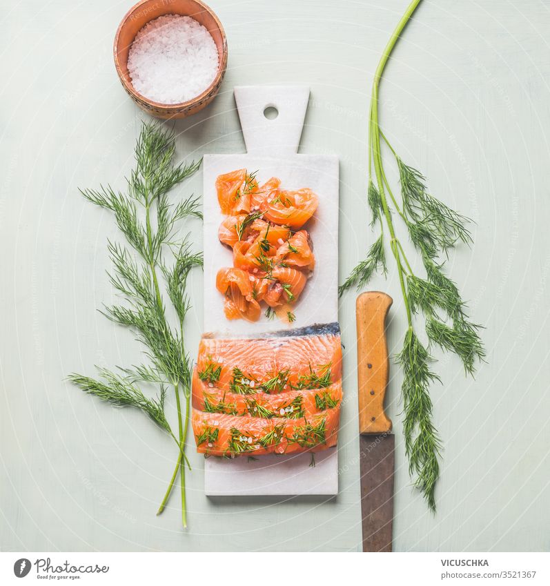 Homemade smoked salmon fillet with dill and lemon served on marble cutting board homemade light background top view healthy food tasty cuisine norwegian