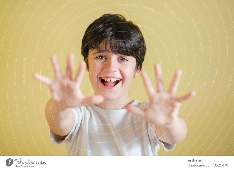 happy kid spreading hands up,background blur child spreading up showing smiling joy sign euphoria euphoric scream cheerful energy excited fun funny expression