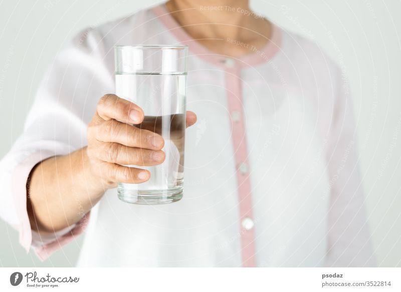 Hands of a girl close up, holding a glass of pure water - a Royalty Free  Stock Photo from Photocase