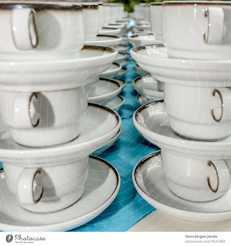 White coffee cups with plates stand stacked in a row Coffee cups mug white utensils drink celebration restaurant break cake pub enjoyment napkin blue cozy