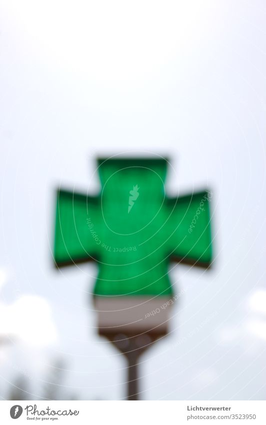 THE GREEN CROSS. Pharmacist symbol blurred in front of the sky Ocean green Sky Signal Pharmacy Green space transmitted transparent Translucent Clouds Summer