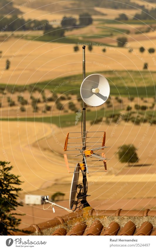 Parabolic Repeater Antenna And Terrestrial Television Antenna On A Roof. science signal engineering broadcast broadcasting telecommunications astronomy european