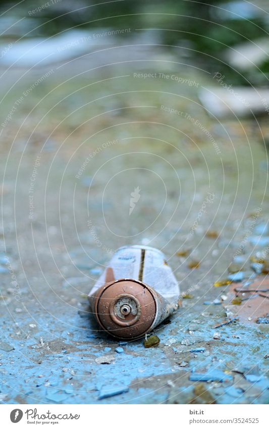 alt l old, blue, cracked, empty spray can, lies on morbid, flaked, broken blue background Environmental sin, pollution, garbage, junk from carelessly irresponsibly thrown away spray can in Lost Place. Non-degradable scrap metal.