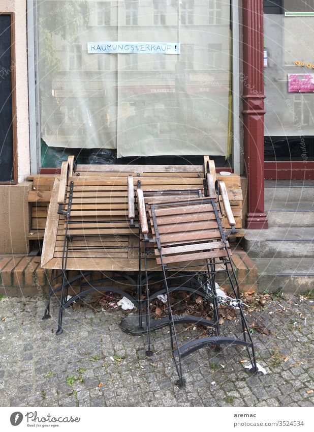 Shop window with sign clearance sale and tables and chairs Sale Chair Table Closed Deserted Exterior shot broke built Window Store premises Colour photo