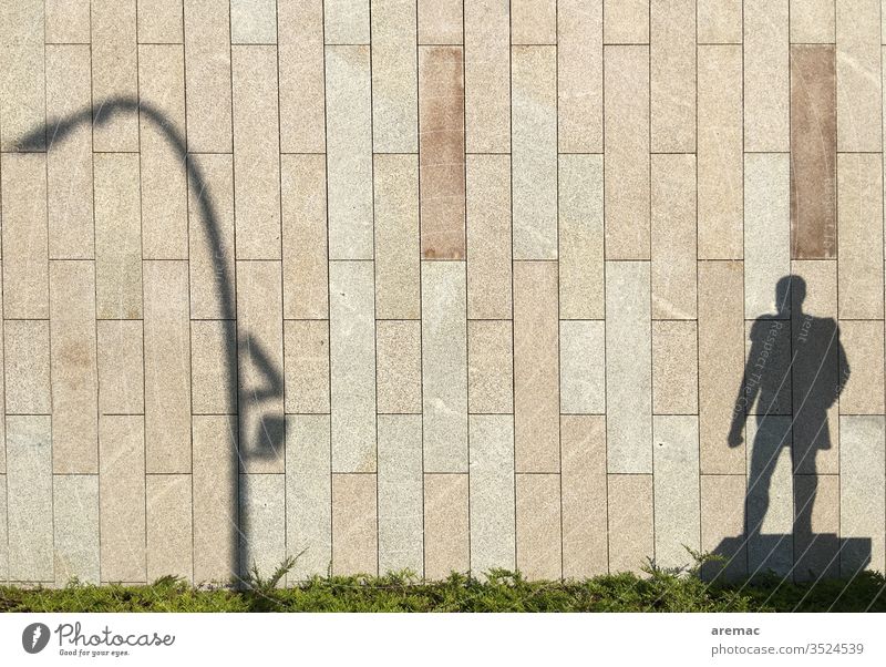 Shadow of a monument and a lantern on the wall Wall (building) Facade Shadow play Light Lantern Man Monument Wall (barrier) Exterior shot Day Deserted