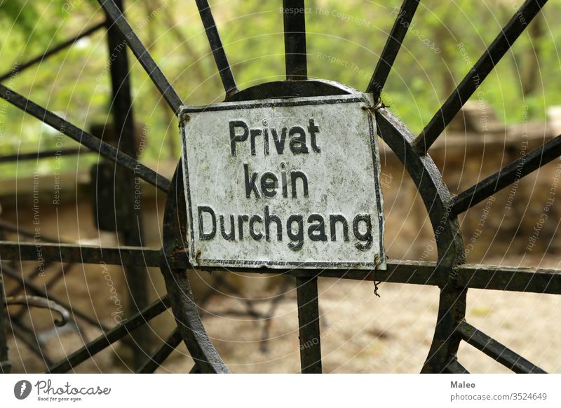 Gate sign. German text: Private No passage access ban enter entry fence forbidden gate metal no prohibited security anger barrier board conflict countryside