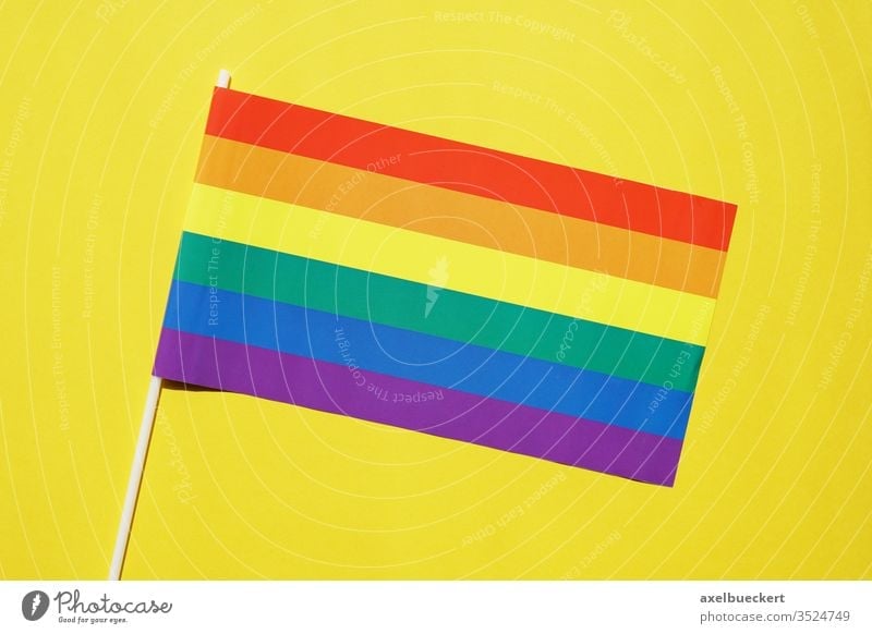 rainbow flag gay or lgbt pride symbol on yellow background diversity lgbtq queer gay pride homosexual lesbian bisexual transgender movement community sexuality