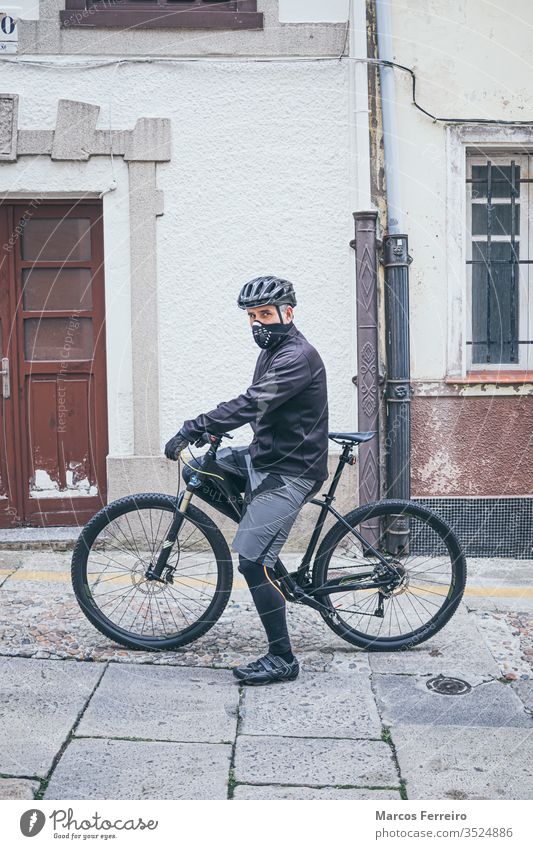 adult man with bike in the city with mask sport viruses corona-virus respiratory face mask outside covid caucasian healthcare covid 19 prevention people