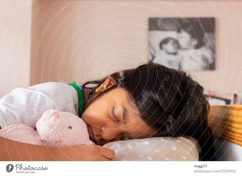 Little girl sleeping on her bed inside her room adorable asleep bear bedding bedroom bedtime brown hair calm care comfort comfortable dream dreaming eyes closed