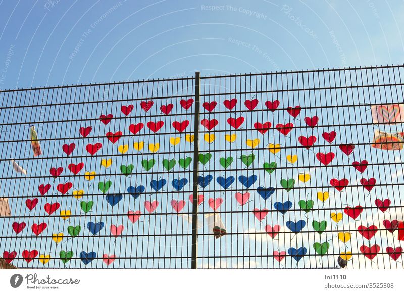 Rainbow on the fence made of many little colorful hearts as a sign of solidarity during Corona corona virus Solidarity Compassion Loneliness Attachment