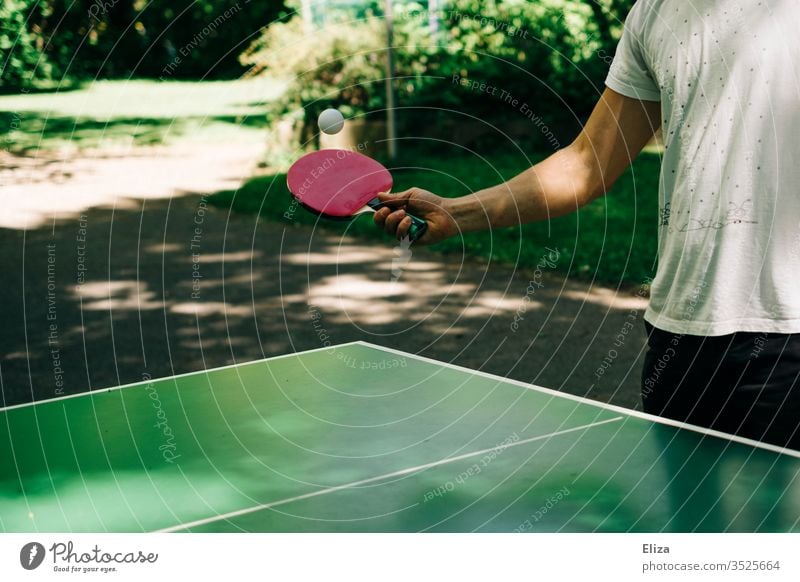 Man playing table tennis outside Table tennis Table tennis table Playing Table tennis bat racket Sports Leisure and hobbies Exterior shot Table tennis ball