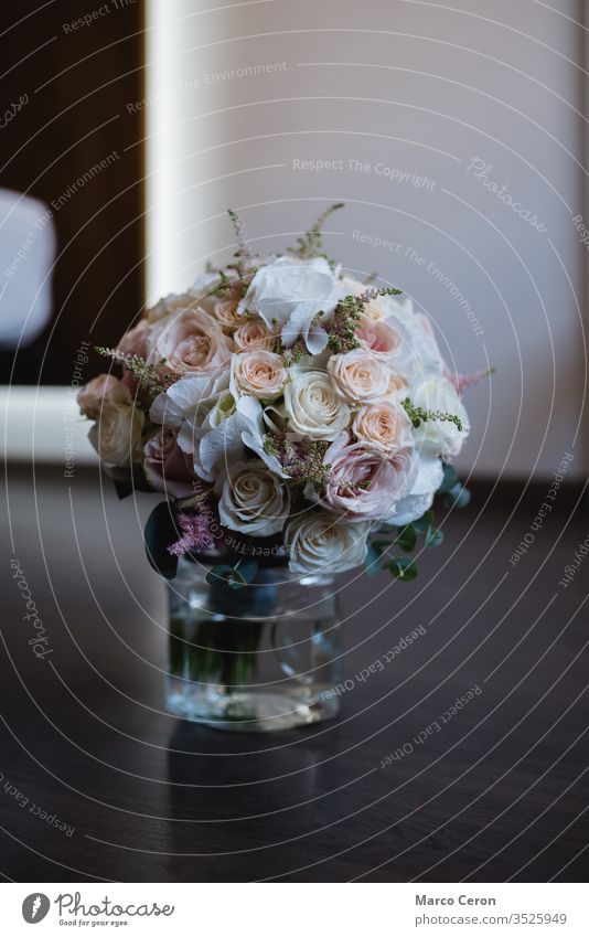 Close up of beautiful bridal roses bouquet in a vase with water on the floor bridal bouquet wonderful flower wedding bouquet decoration bride florist beauty