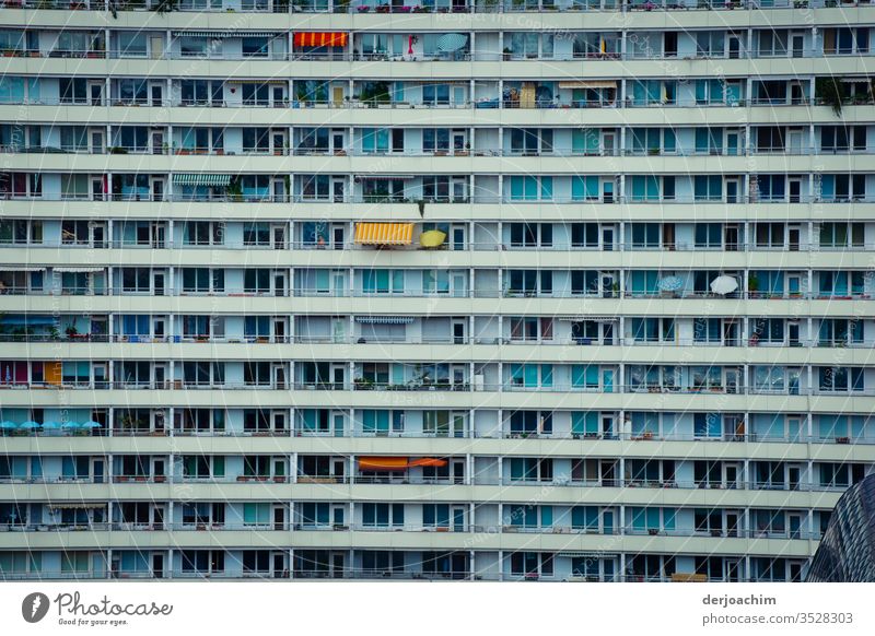 "In the middle of Berlin " Plattenbau facade, with many windows and balconies. There are also a few sunshades. High-rise Facade Window Architecture Building