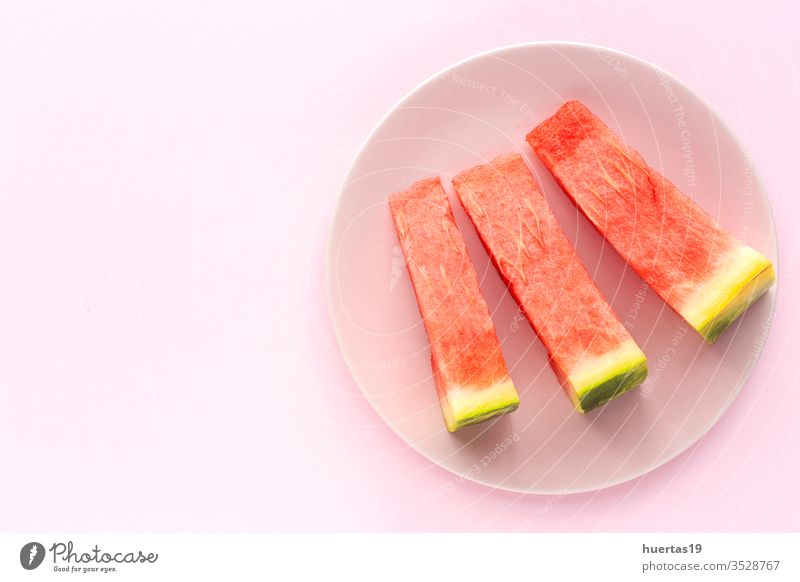 Fresh watermelon on pink background from above fruit summer fresh diet refreshment food healthy sweet cold green ripe vitamin freshness nutrition slice flat lay
