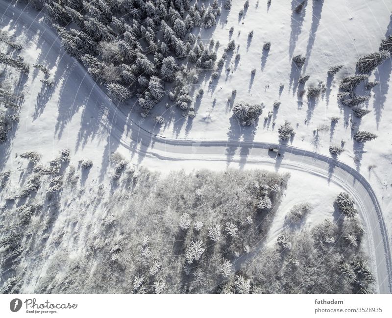 Winter road in forest aerial view Aerial photograph Bird's-eye view Car Driving Ice Frost Snow Weather Forest Tree Landscape Wide angle Curve Vacation & Travel