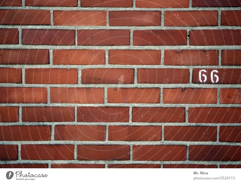 66 House number Digits and numbers Sign Wall (barrier) Wall (building) sixty-six Brick wall brick wall Red mark lines oldstyle Orientation Information