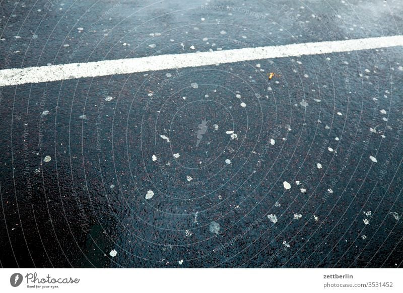Parking place with chewing gum Parking lot chewing gum Street Asphalt Pavement Wet Water Rain Chewing gum dirt filth unclean Patch Point Line mark Lane markings