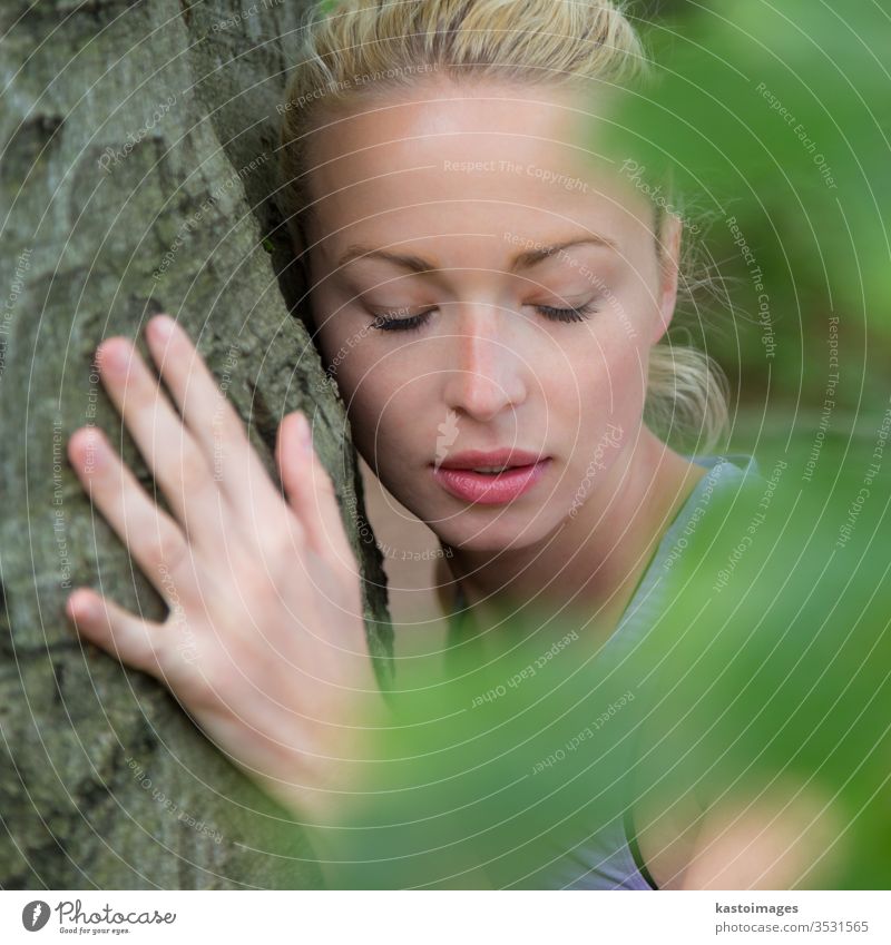 Young woman hugging a tree. hugger embracing embrace forest harmony trunk balance spiritual spirituality listen person wood green nature energy environment love