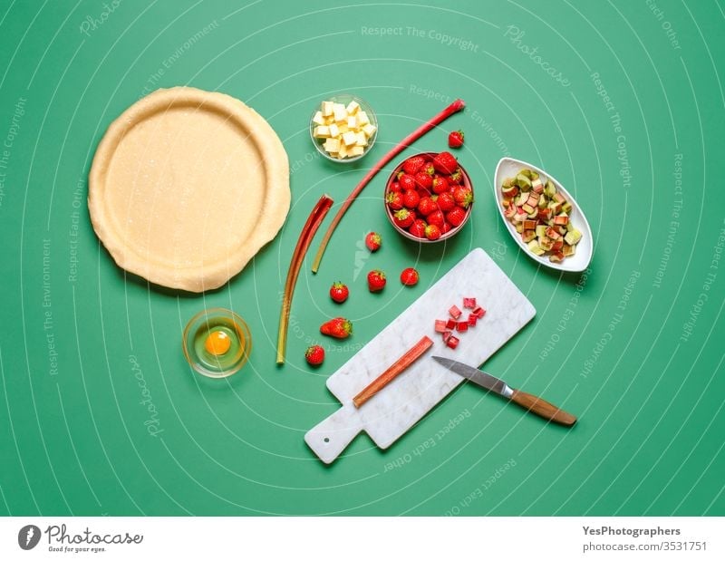 Making a pie at home. Strawberries and rhubarb pie ingredients above view bake bakery baking butter cake chopping crust cuisine delicious dessert dough flat lay