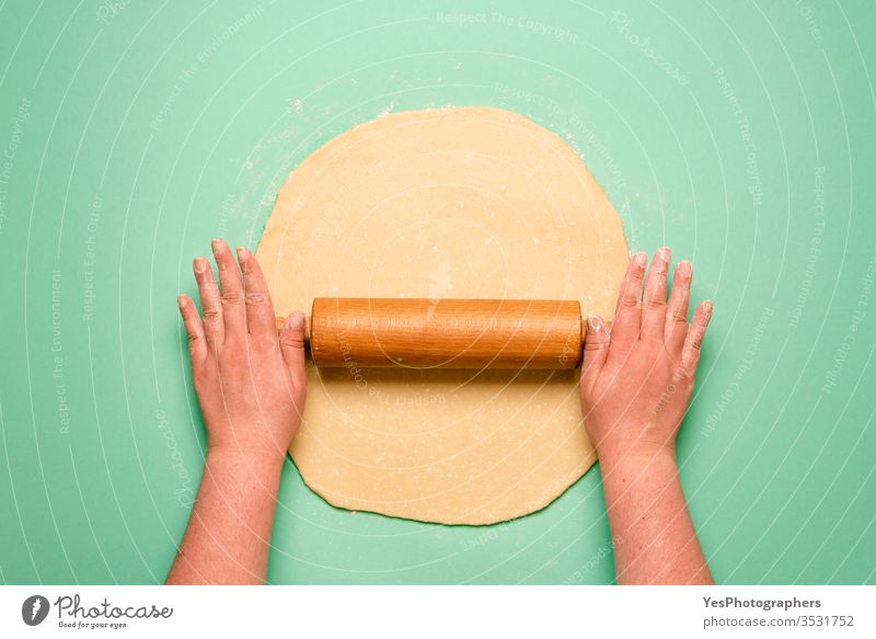 Making a pie top view. Woman stretching the dough on green table above view baker bakery baking cake cook crust cuisine culinary dessert domestic