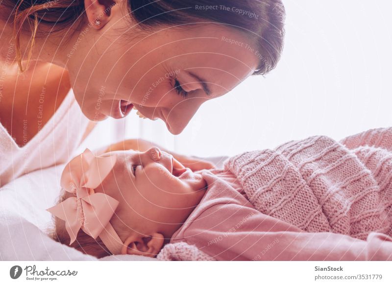Portrait of mother and child laughing and playing baby mom happy family kid beautiful happiness young love daughter little white cute healthy girl woman