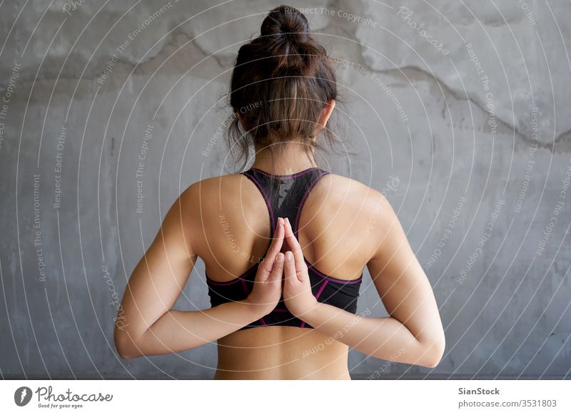 Beautiful yoga girl doing asanas in studio Stock Photo by