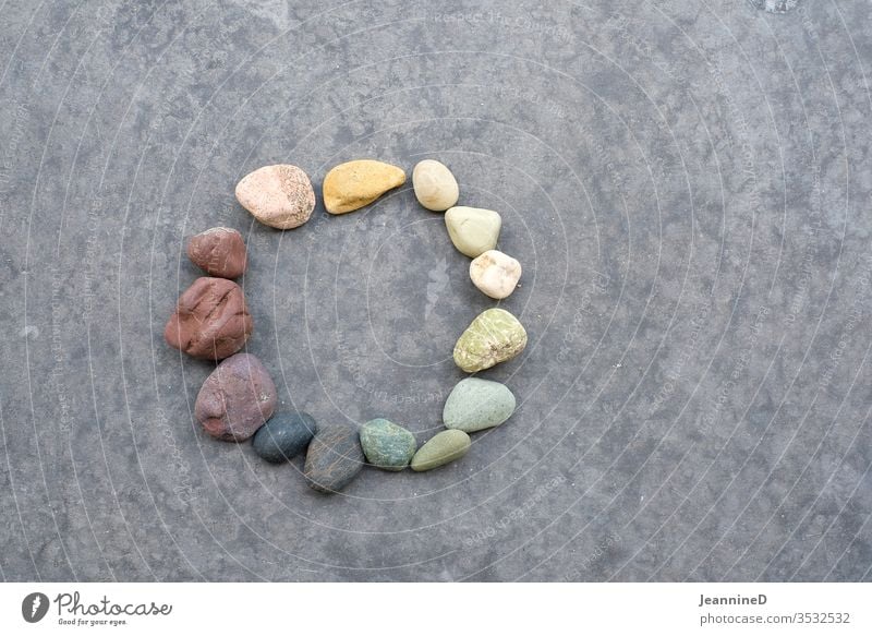 Coloured stones in a circle Circle circulation Nature Yoga Round Cardiovascular system Transience Harmonious grey background symbolic Future centred Patient