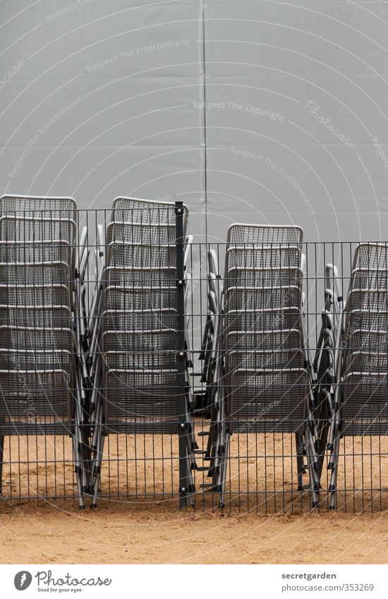 impostor. Chair Event Metal Sit Tall Brown Gray Contentment Stack pile Sand Wait Orderliness Arrangement Fence Colour photo Subdued colour Exterior shot