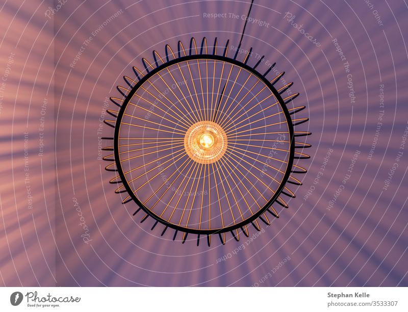 Geometrically arranged light beams of a lamp photographed exactly vertically from below. Wall (building) Lamp Striped Abstract Under Modern natural overshadow