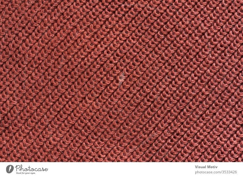 Texture of a red wool knitted fabric textile textured fashion background surface design abstract closeup nobody detail knitwear clothing material relief woolen