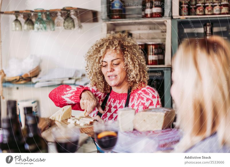 Cheerful seller communicating with client speak product happy work service grocery copy space hair curly talk employee friendly smile store dairy shop purchase