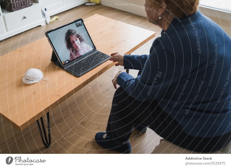 Old woman communicating with daughter on video chat on laptop video call home senior meeting using online remote distance coronavirus isolation quarantine