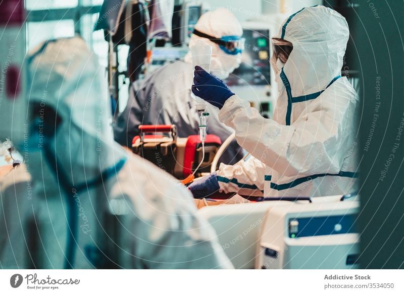 Group of professional doctors working in operating room during pandemic uniform equipment clinic glove specialist examine check occupation protect health care
