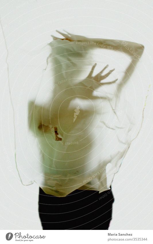 Body behind a translucent paper Woman Paper hands expression fear tension