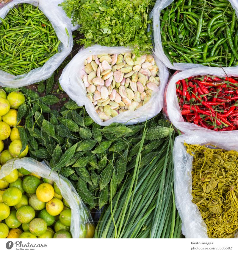 Farmers market with various domestic colorful fresh fruits and vegetable. food marketplace farm vegetarian cucumbers beans variation basket stand background