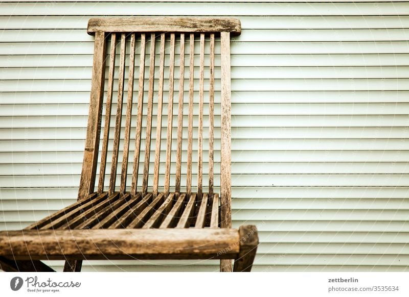 Folding chair in front of closed blinds Garden chair Chair Relaxation Venetian blinds Empty Free allotment Garden allotments Deserted tranquillity Garden plot