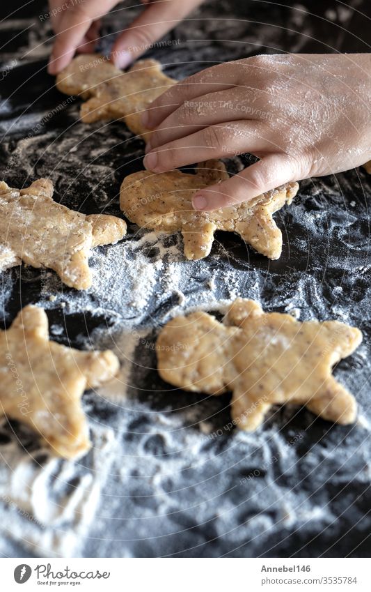 person bakes gingerbread man biscuits, person hands dough with flower in cosy kitchen Christmas Dough Flour Self-made Gingerbread traditionally Dessert Bread