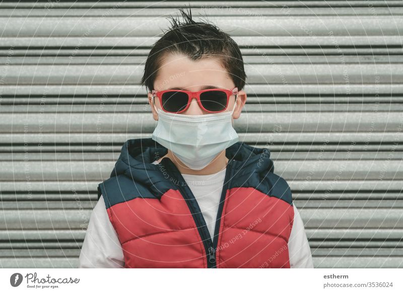 kid wearing medical mask for coronavirus with sunglasses child epidemic pandemic quarantine covid-19 symptom medicine health childhood protection cool summer