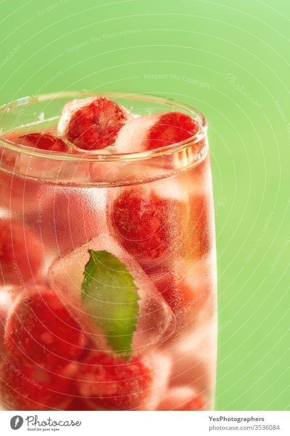Glass of water with frozen raspberries. Cold drink. beverage cold cool crystal detox diet dieting fluids freeze fresh frost frozen fruits glass glass of water
